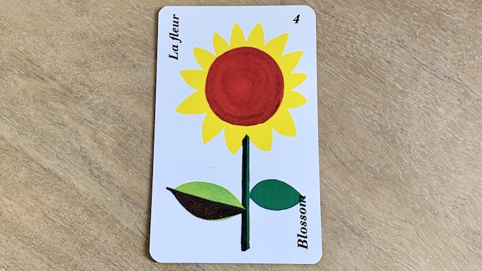 Carte Fleur de l'Horoscope Belline montrant un tournesol jaune au cœur rouge avec feuilles.