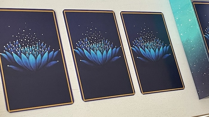 Dos des cartes de l'Oracle Bleu, motif fleur de lotus bleu sur fond sombre
