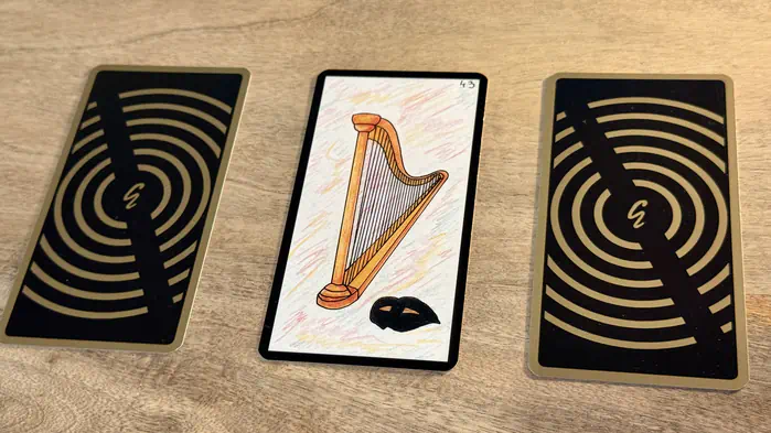 Une harpe et un masque, illustration de la carte 43 de l'Oracle Gé : La Harpe.